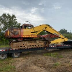 komatsu pc200lc-7 excavator with burn damage on the engine compartment door on a trailer for salvage gulf south equipment sales baton rouge louisiana