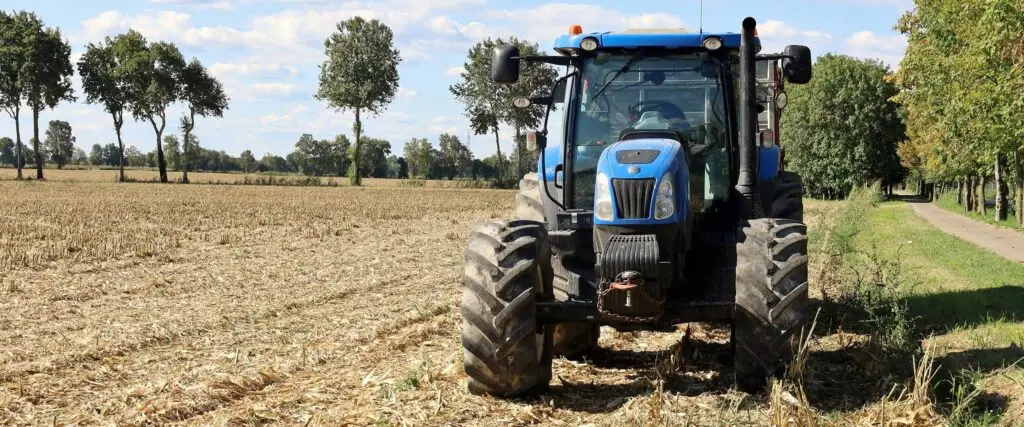 Blue New Holland tractor in a field